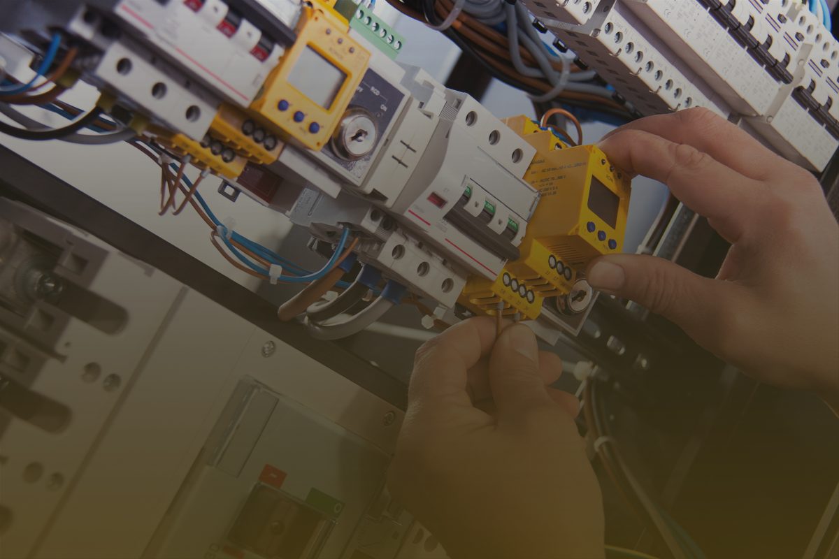 male electrician works switchboard with electrical connecting cable2